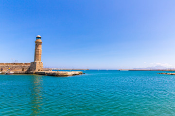 Old venetian lighthouse at harbor. Rethymno, Crete, Greece