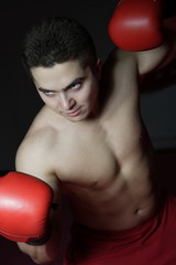 Boxer with gloves on training in the gym