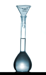 Isolated chemical volumetric flask on table with funnel