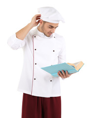 Professional chef  with book, in white uniform and hat,