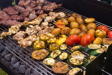 Meat and vegetable barbeque over coals