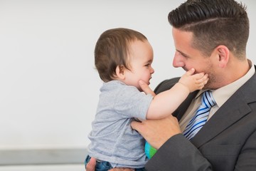 Businessman touching cheek of baby boy