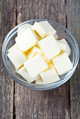 Fototapeta na wymiar fresh butter in a glass bowl on wooden surface