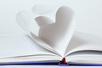 Heart shape of diary pages on a white background