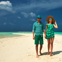 Couple in green on a beach at Maldives