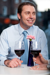 Happy couple toasting red wine