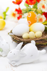 Easter rabbits and basket with eggs, close-up