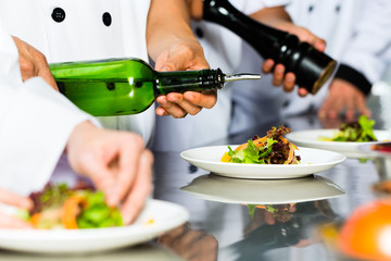 Asian Chef in restaurant kitchen cooking