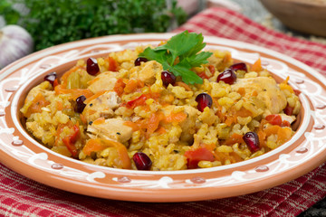 pilaf with vegetables, chicken and pomegranate, close-up