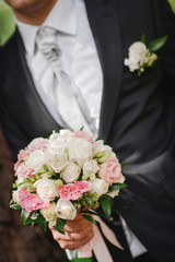 groom with flowers