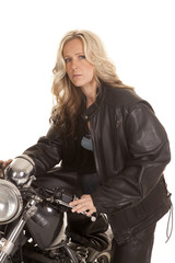 Fototapeta na wymiar Woman leather sit on motorcycle jacket look
