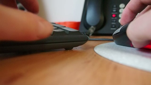 Closeup of the human hand works with mouse and keyboard.