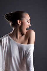 Fototapeta premium Profile of happy beautiful girl posing in studio