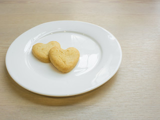 Heart cookies on white plate .Space for text