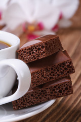 cup of coffee and aerated chocolate. macro vertical