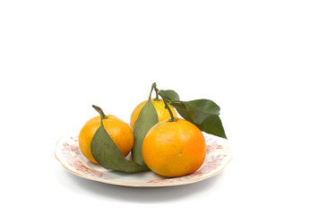 Ripe tangerine on the side plate