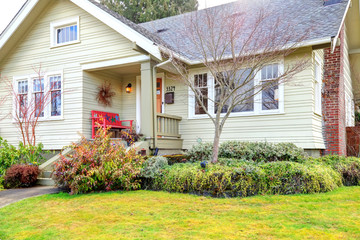 Small front porch with red bench
