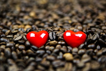 Two red hearts in coffee beans