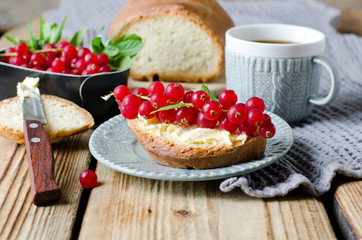 Homemade bread with butter and red currant