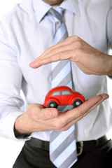macro red toy car in businessman hand