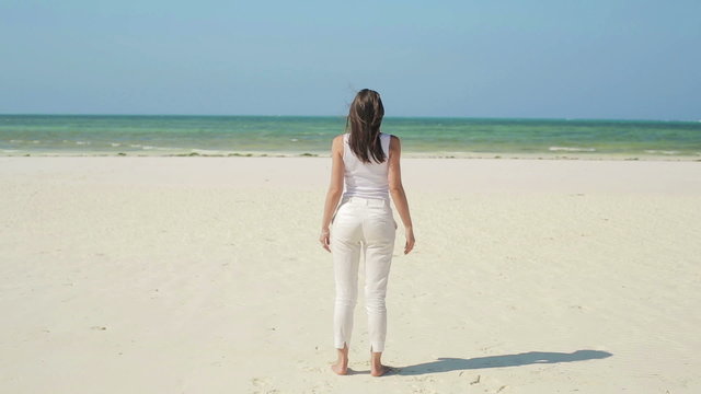Woman standing on beautiful exotic beach