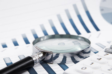 Obraz na płótnie Canvas magnifying glass on the business report
