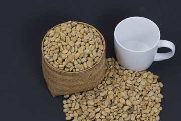 Coffee beans on wicker Basket and coffee mugs.