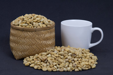 Coffee beans on wicker Basket and coffee mugs.