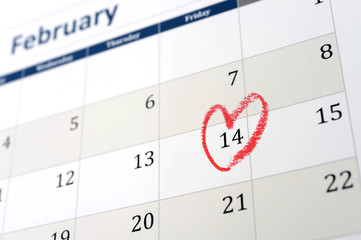 calendar page and little red heart marking valentines day