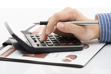 Fototapeta premium Male hand with pen analyzing financial data