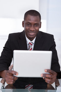 African Businessman Holding Digital Tablet