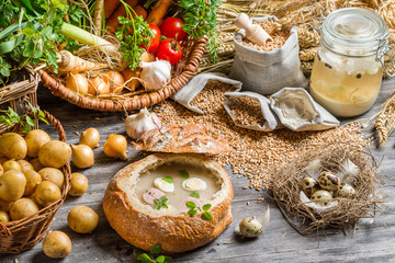 Soup served in bread with sausage and egg