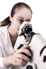 Young woman looking through microscope