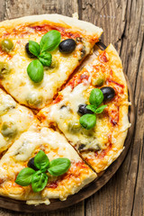 Closeup of freshly baked pizza with cheese and basil