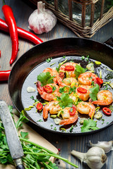 Shrimps served on a pan with herbs
