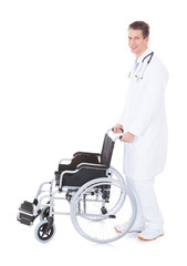 Young Male Doctor Pushing Wheelchair