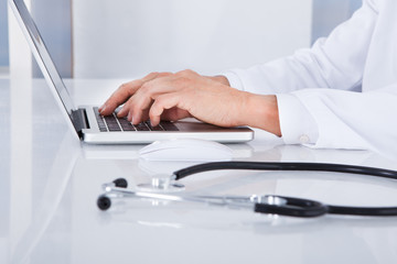 Close-up Of Doctor Using Laptop