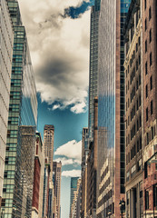 Fototapeta na wymiar Manhattan. Wonderful view of tall skyscrapers from street level