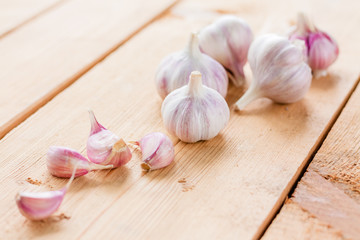 raw garlic on a wooden plank