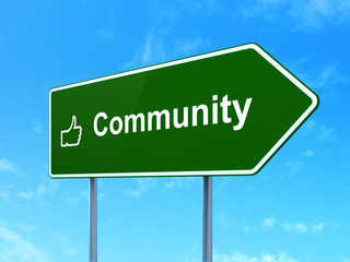 Social network concept: Community and Thumb Up on road sign