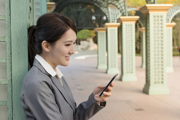 Fototapeta na wymiar Attractive business woman use smart phone