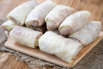Fototapeta na wymiar Uncooked cabbage rolls stuffed with ground meat and rice