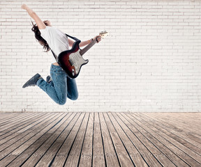 girl jumping with electric guitar - Powered by Adobe