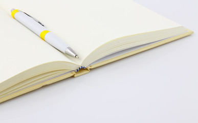 close up notebook and pen on white background