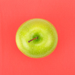 Green apple on red napkin