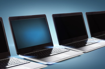 many laptop computers with blank black screens