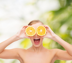 amazed young woman with orange slices
