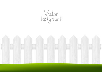 White wooden fence with green grass