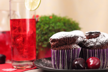 Chocolate muffins and glass of berry drink