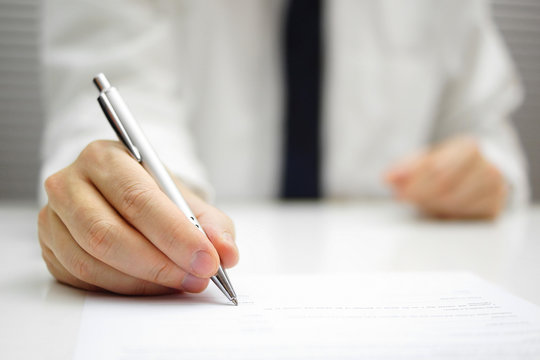 businessman is signing  contract